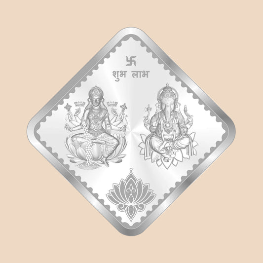Diamond-shaped silver foil with two seated figures and a lotus design on a white background