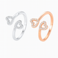 Two heart-shaped rings, one silver and one rose gold, on a white background.