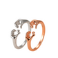 Two rings, one silver and one rose gold, on a beige background with 'Hug Your Style' text.
