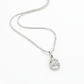 Silver necklace with a heart-shaped pendant on a white background