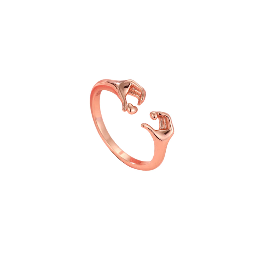Rose gold ring with a unique design on a pink background