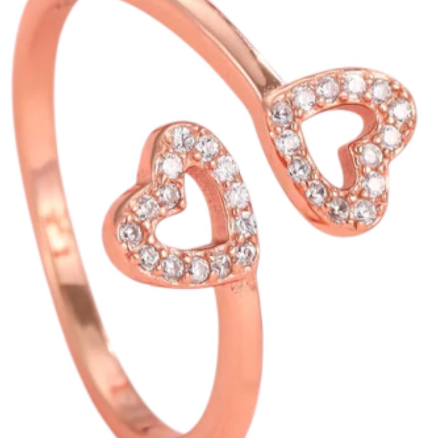 Rose gold ring with heart designs on a white background